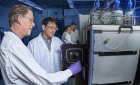 Scientists examine mass spectrometer