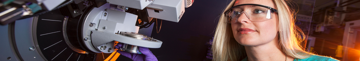 Science Intern working with technical machine.
