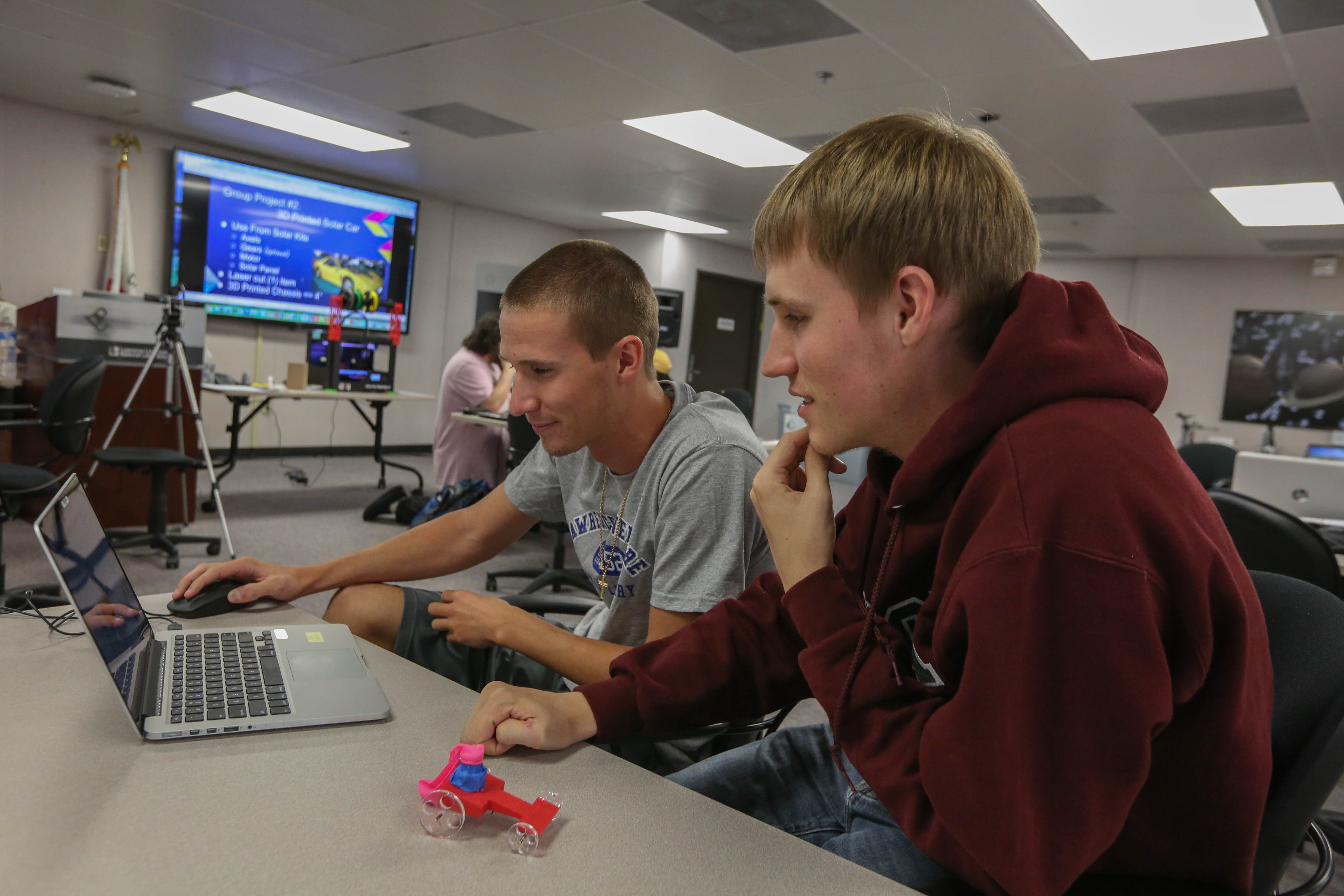 students work on laptop