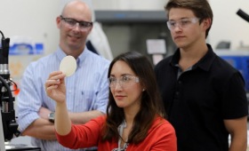 image of researchers holding 4D printed material
