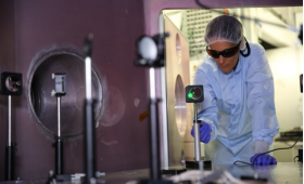 Félicie Albert prepares the tabletop-sized Titan laser system