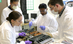 Engineers work on a cubesat.