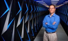 Barry Chen standing next to Sierra mainframes