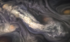 High-altitude cloud formation surrounded by swirling patterns in the atmosphere of Jupiter's North North Temperate Belt region.