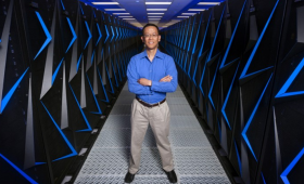 Barry Chen among racks of supercomputers