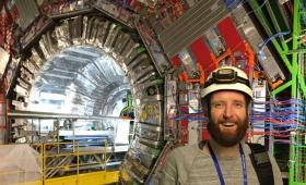 Scientist in front of the CMS detector