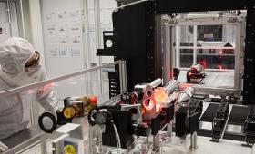 Researcher inspects laser equipment