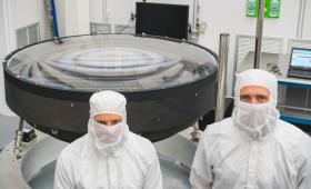Large lens with two people in protective suits