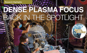 Two students work on the dense plasma focus instrument
