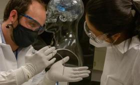 Two scientists examine thin-film electrode
