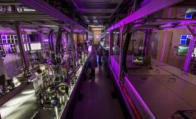 Scientific equipment on room-length lab bench, left, with person in middle.