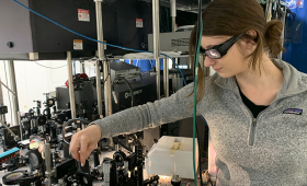  Sophiesized823-453  Ph.D. student Sophie Parsons conducts laser alignment work on an ultrafast pulse table-top laser system modified for sub-nanosecond shock compression and velocimet.