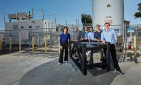 Researchers pictured with a hydrogen storage system