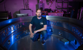 LLNL postdoc Sam Hedges sits inside the high voltage test bed (referred to as LXTS) for nEXO experiments.