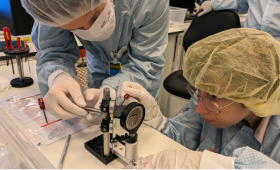 Elizabeth Grace (LLNL, right) and Filip Grepl (ELI Beamlines, left) assemble the PROBIES diagnostic, one of many instruments that fed data to the machine-learning optimizer algorithm.