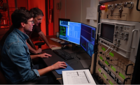 LLNL biologists David Baliu-Rodriguez (left) and Mike Malfatti examine the Accelerator Mass Spectrometry results showing the quantification of carbon-14 labeled-subedatex in tissue.