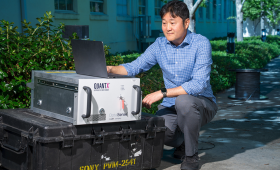 Lab seismologist Gene Ichinose looks over an interrogator, an instrument that allows buried fiber-optic cable to be turned into thousands of virtual seismometers that can be used to measure the ground motion of the Earth and structures.