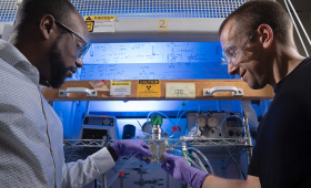 LLNL scientists Jeremy Feaster and Steven Hawks are collaborating on a process to convert wastewater into clean water and recovered fertilizer. Here they hold the electrochemical reactor for the final step of the process.