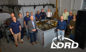 Lawrence Livermore National Laboratory and Pacific Fusion leaders and researchers gather around the SIRIUS pulsed-power prototype during a May 15 celebration marking the system’s 3,000-shot milestone at LLNL. 